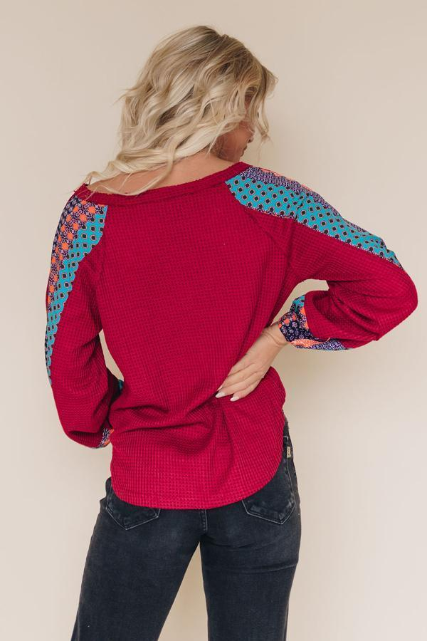 Burgundy thermal top with blue patterned sleeves, crew back, long sleeves