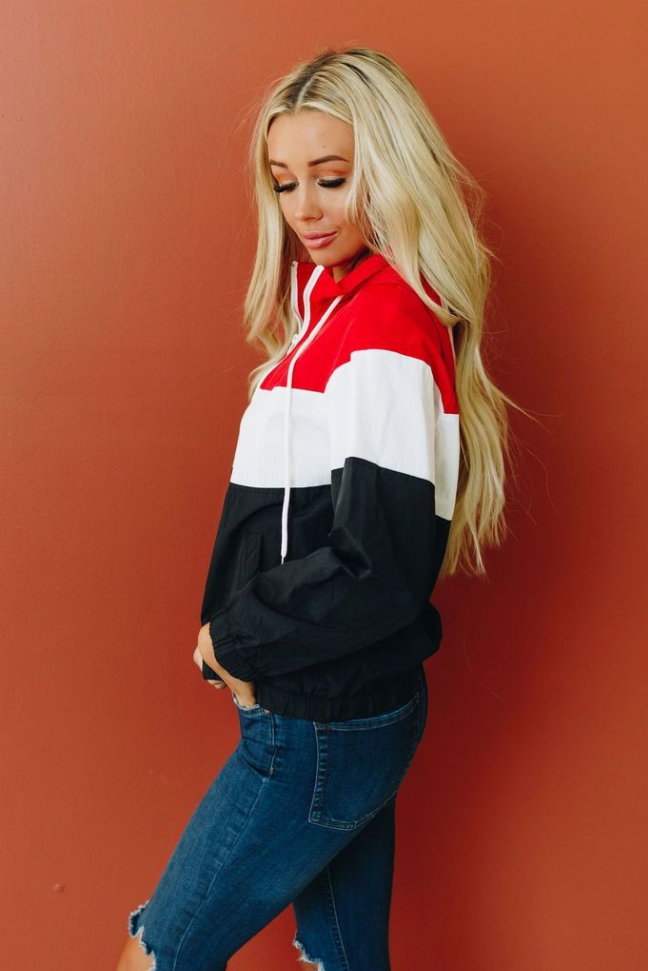 Side view hooded windbreaker, red, white, and black colorblock panels with zipper.