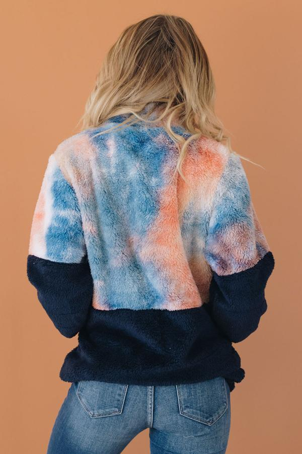 Tie-dye fuzzy pullover with half-zip and black cuffs, rear view