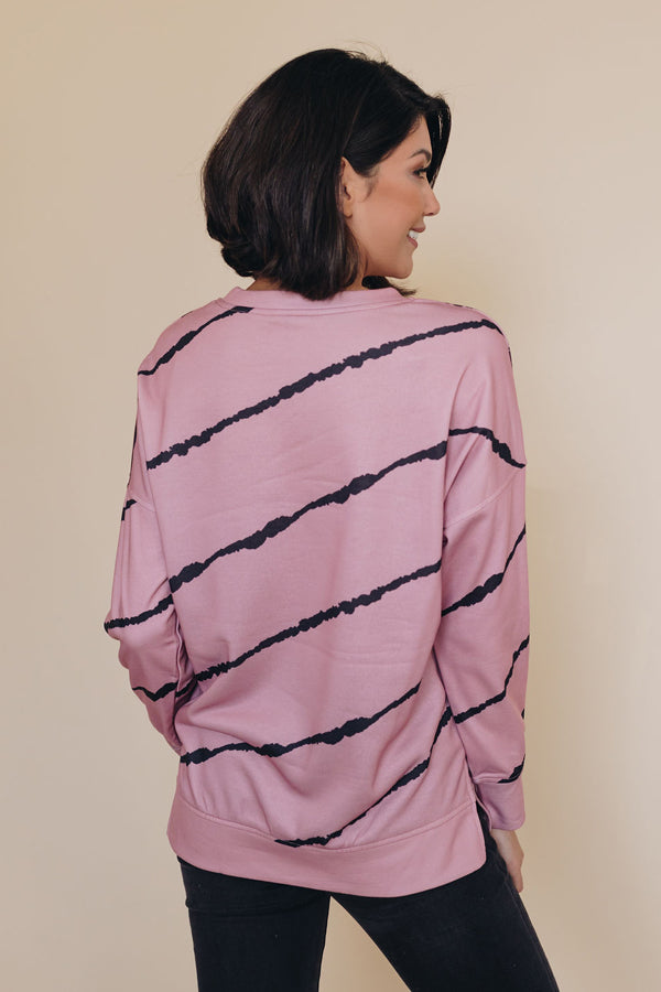 Back view: pink pullover sweatshirt with black tie-dye stripe pattern and long sleeves.