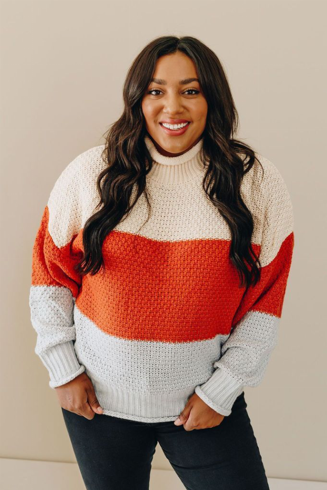 Color-block turtleneck sweater in white and red-orange stripes, front view