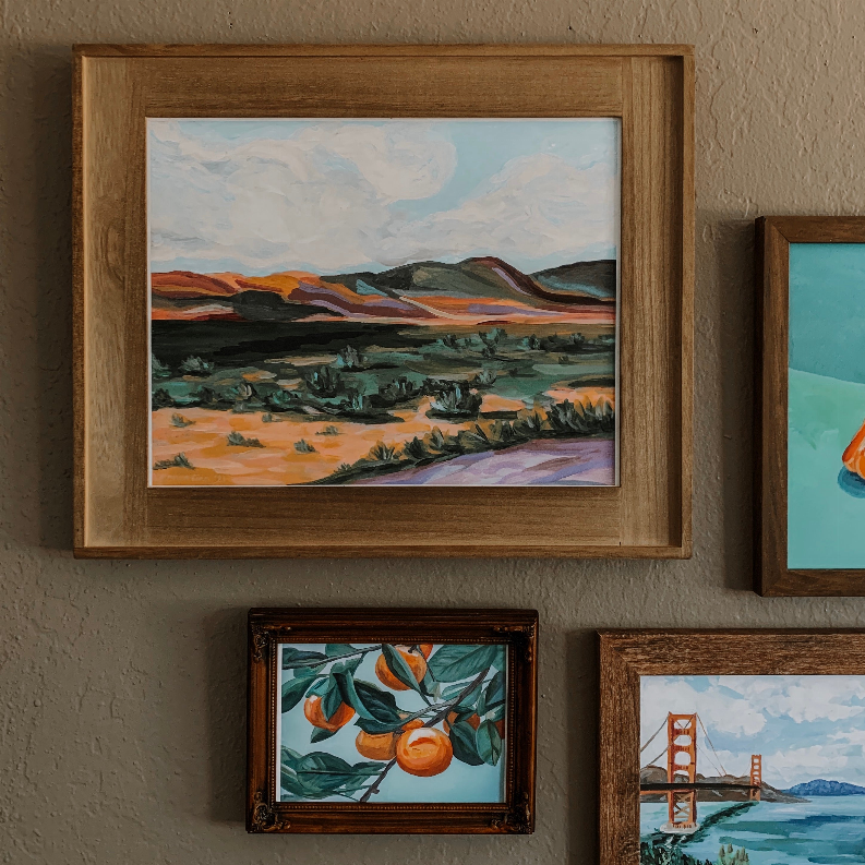 Partial framed orange branch floral painting with green leaves and orange blossoms