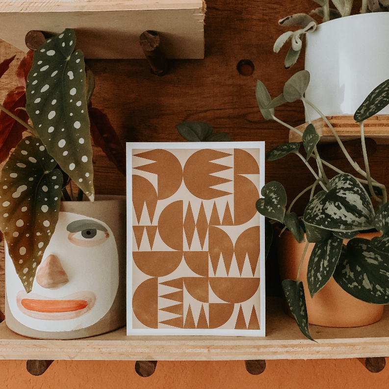 Framed woodblock-style art print featuring abstract tan geometric shapes