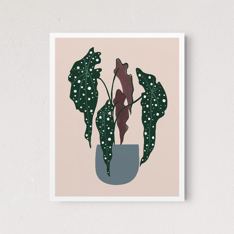 Framed botanical artwork with dark green polka-dot leaves and a beige pot centerpiece