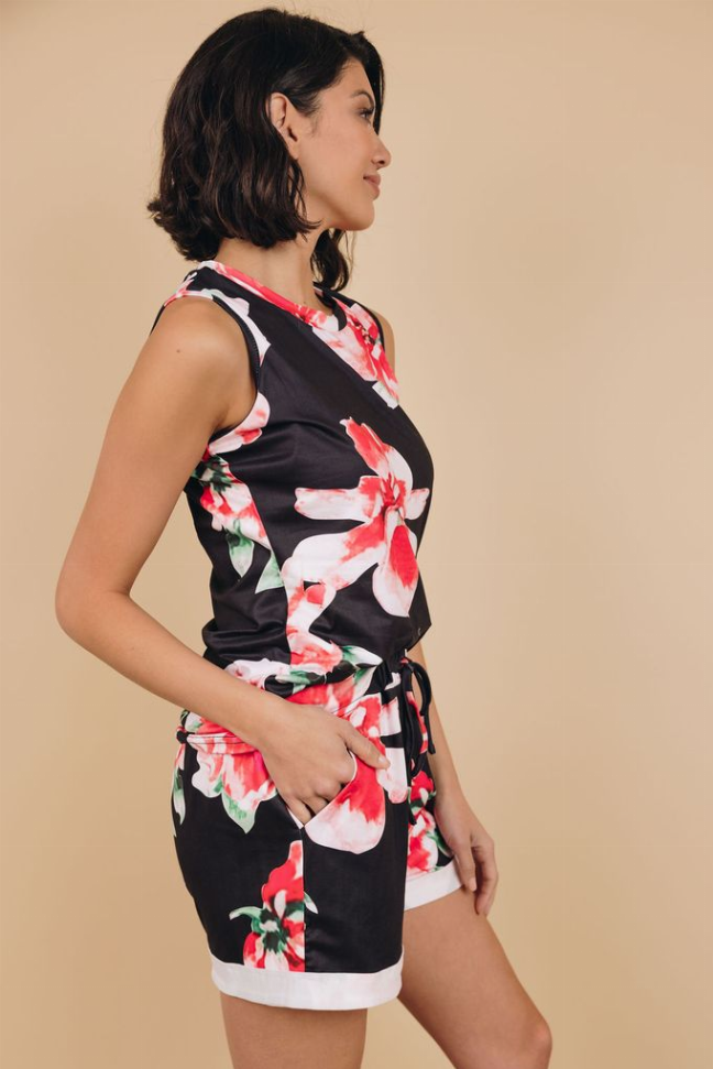 Side view of floral loungewear set: sleeveless black top with red flowers and shorts