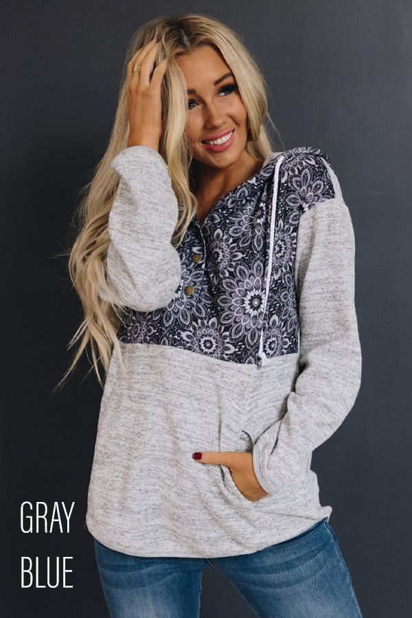Gray heather pullover hoodie with tribal-pattern hood and kangaroo pocket, front view.