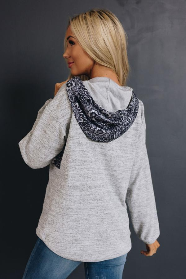 Gray heather hoodie with tribal-pattern hood detail, back view.