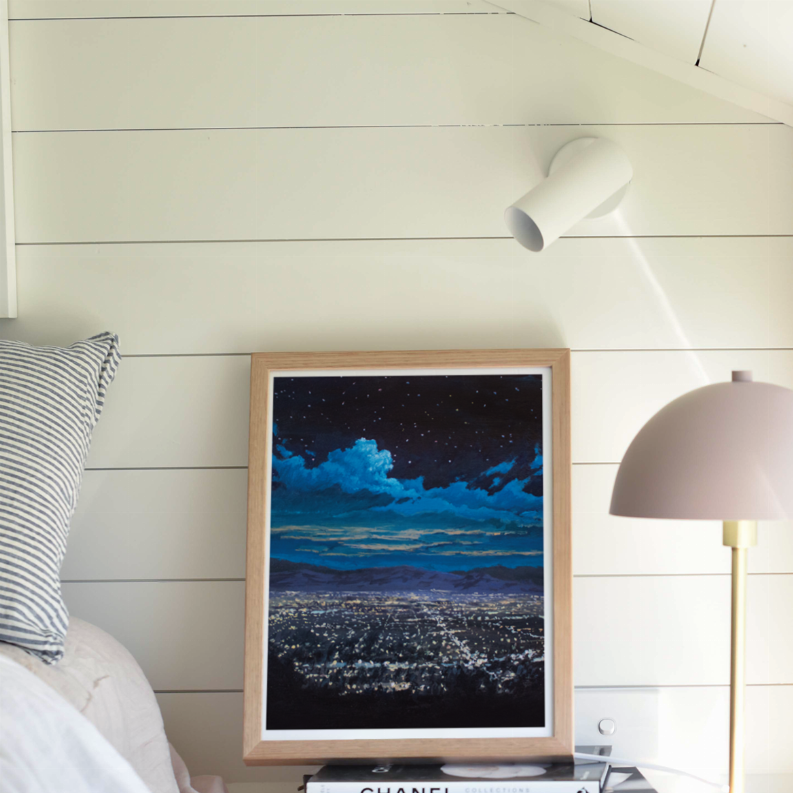Framed night cityscape wall art print, light wood frame, blue and dark starry sky