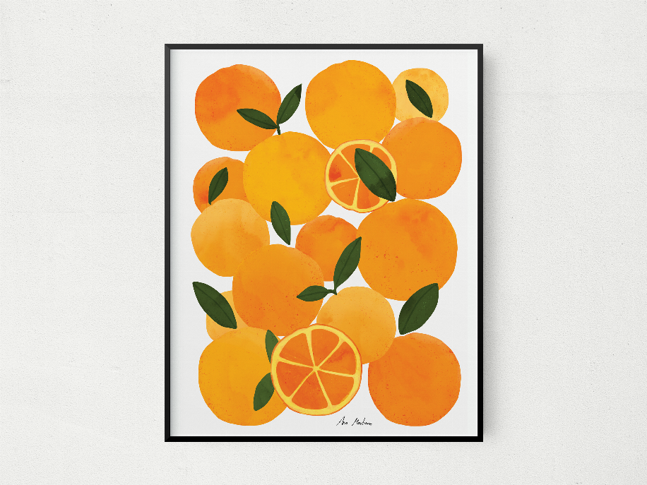 Black-framed orange fruit wall art with citrus slices and green leaves