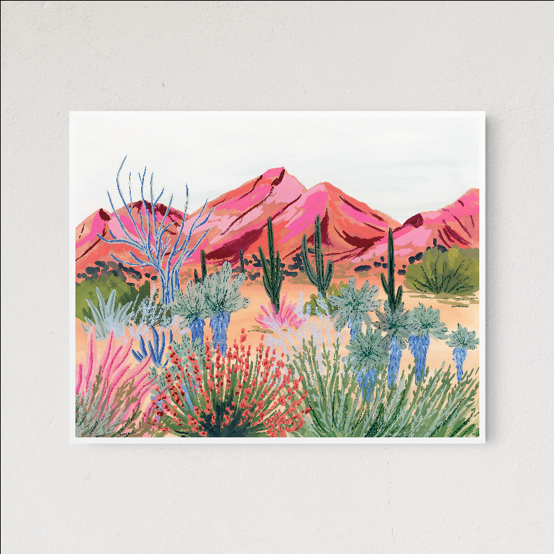 Framed desert landscape art print showing pink desert hills and blue-green cacti