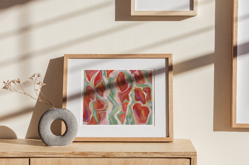 Framed abstract tree bark print with layered coral and teal shapes inside wood frame