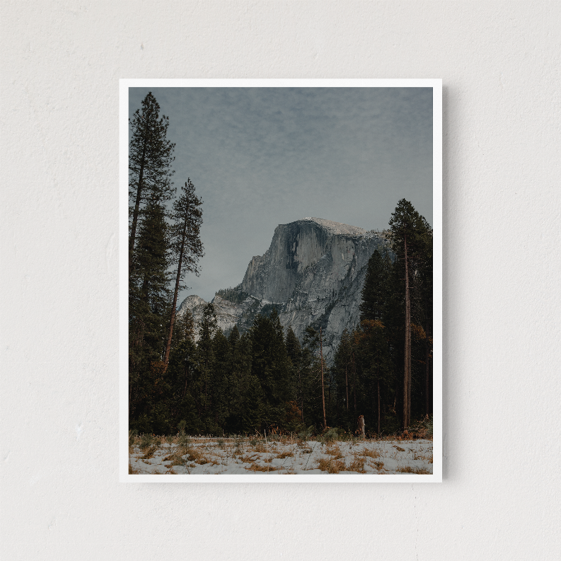 Square framed Half Dome landscape photo in a white frame with pine trees and snow