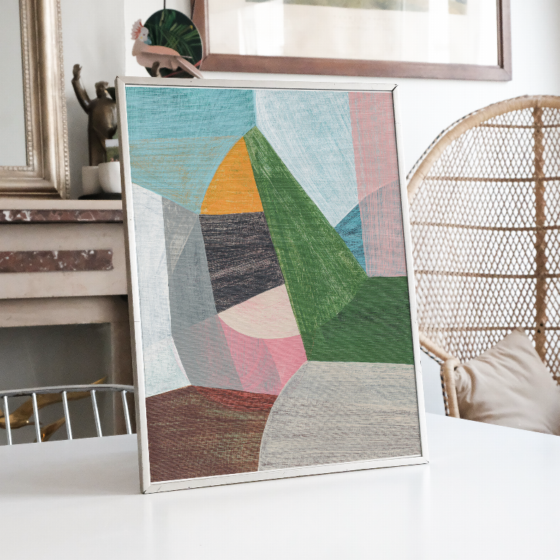 Standing framed abstract print with geometric shapes in blue, green, orange, and tan