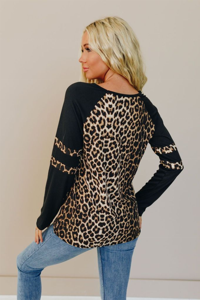 Leopard-print varsity long-sleeve tee from side-back angle with black sleeve stripes