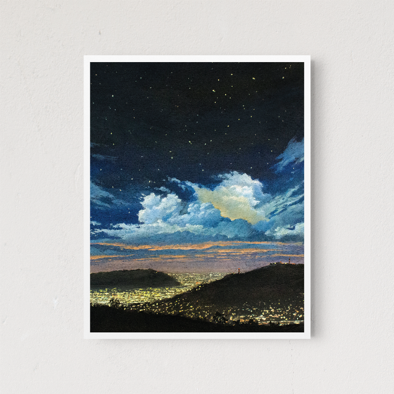 White-framed landscape wall art with starry night sky, large clouds, and glowing horizon