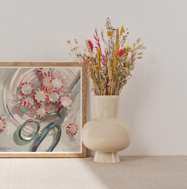 Wood-framed peppermint pile art print beside beaded glass vase with dried wildflowers