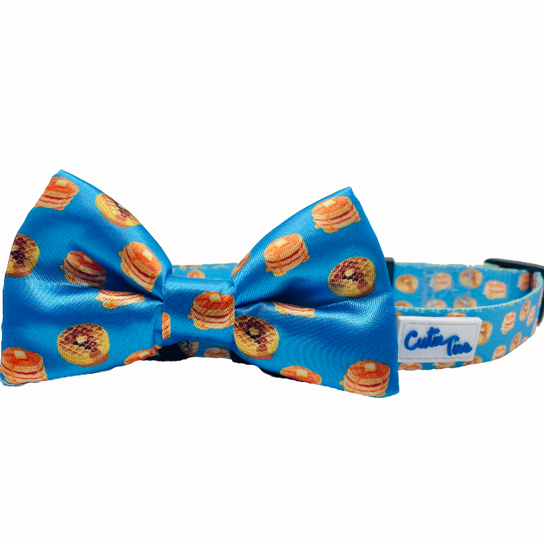 Blue dog collar bow featuring hamburger graphics in orange and brown tones