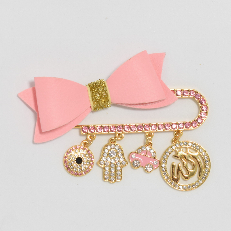 Pink ribbon baby safety pin with gold-tone glitter charms and hamsa pendant disc