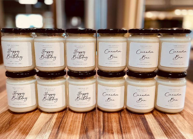 Soy candle set in glass jars with dark lids; white wax and printed labels