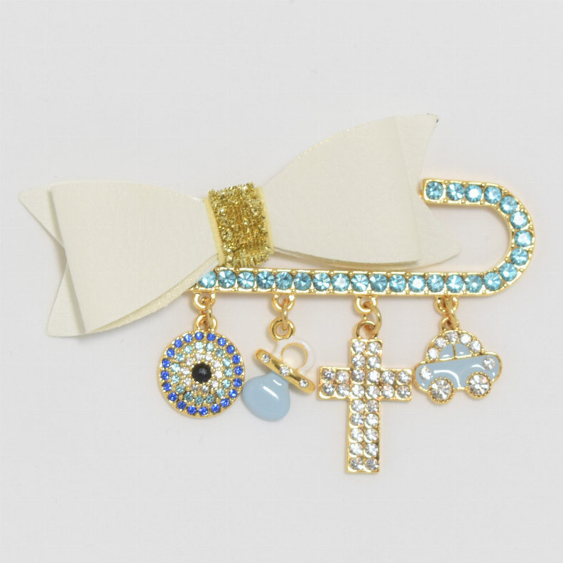 Gold-tone rhinestone baby pin with bow backing and hanging cross, eye, pacifier charms