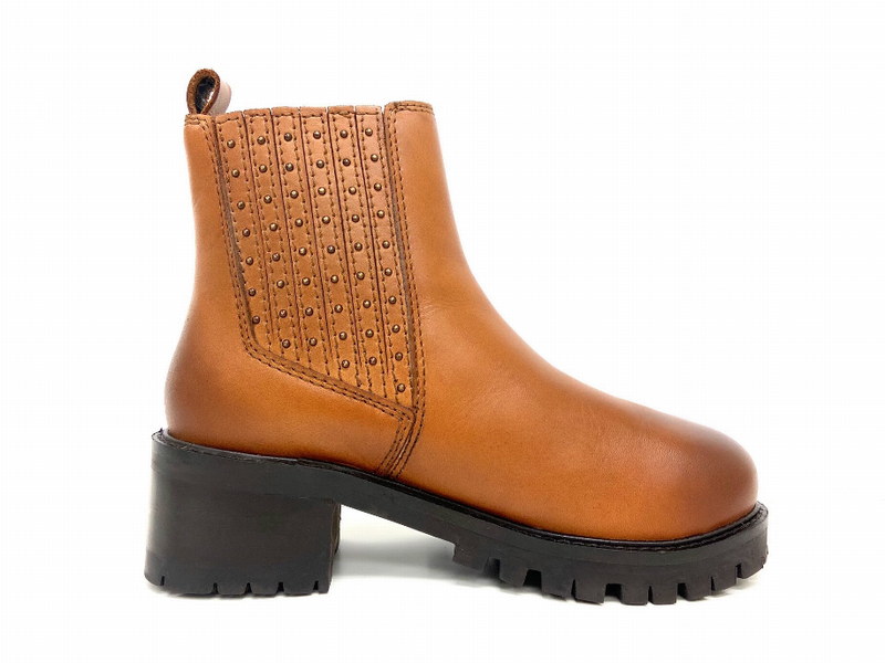 Tan platform Chelsea boot side view with studded gore and thick black lug sole