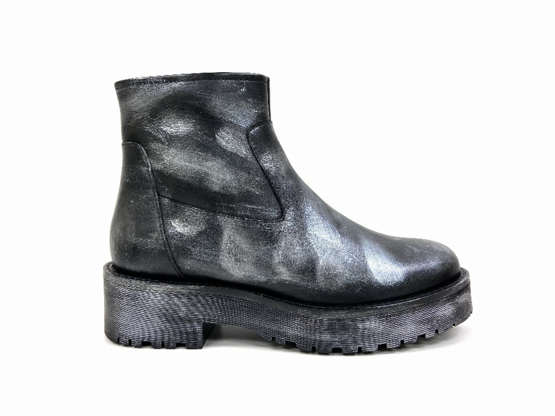 Black ankle bootie with side zipper and textured lug sole, shiny leather finish