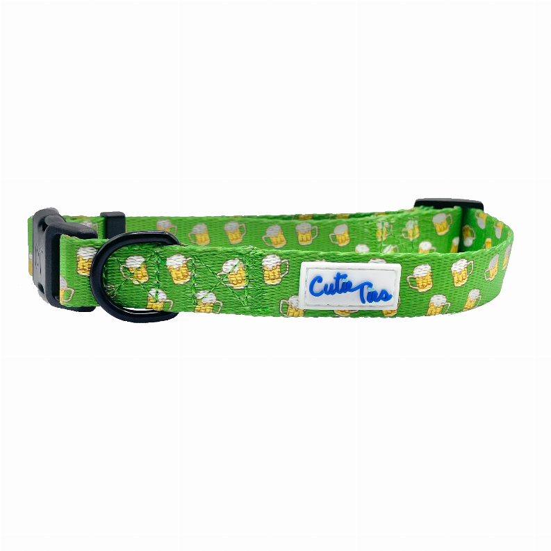 Green dog collar with cactus and dog faces print, black buckle and logo patch