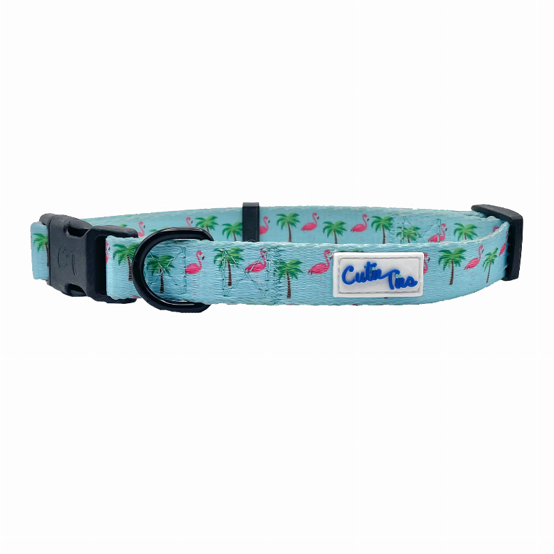 Dog collar with flamingo and palm print, turquoise webbing, black hardware and logo label.