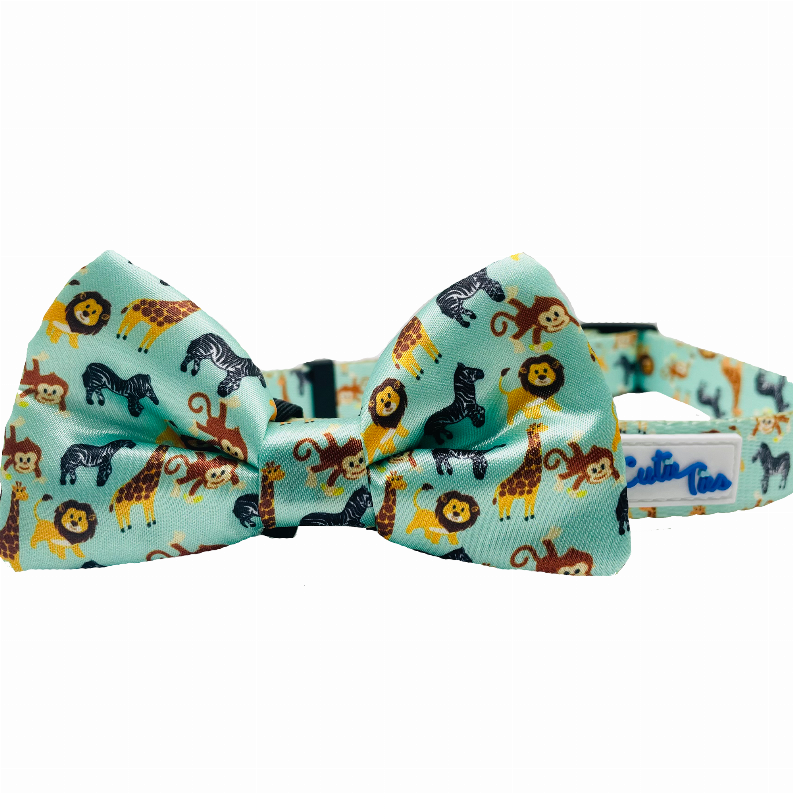 Animal-print turquoise dog collar with matching bow and navy adjustment strap