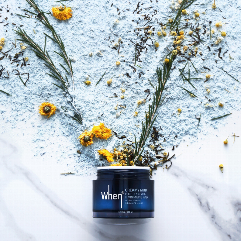 When Creamy Mud mask jar on white marble, blue label and silver top