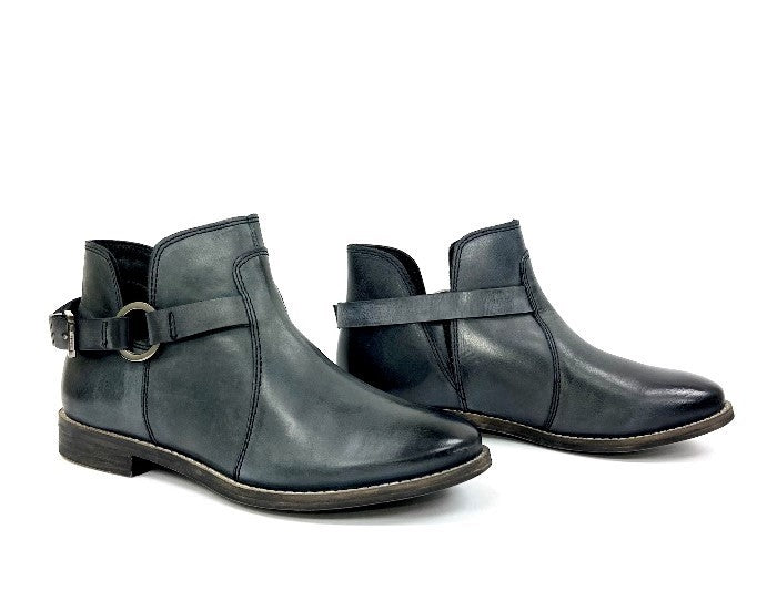 Dark teal ankle booties showing buckled strap and side elastic gore panels