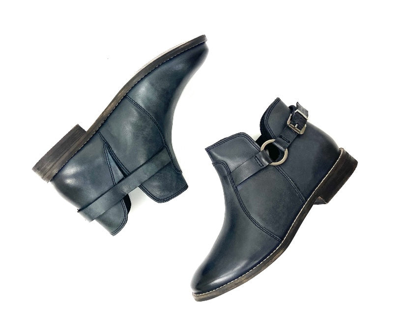 Two dark teal ankle booties with side buckle strap and blocky heel