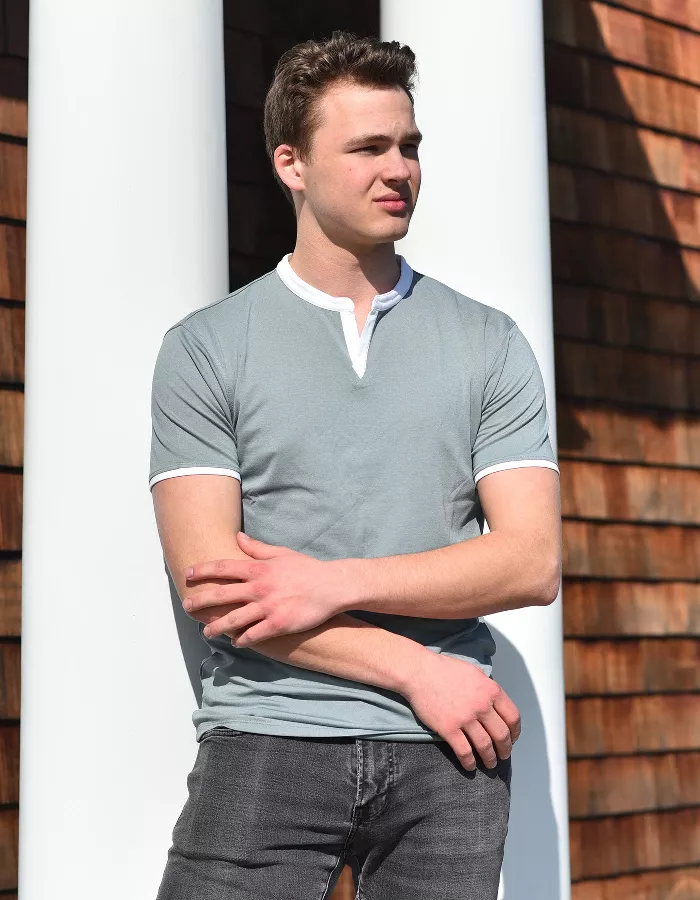 Light blue polo-style notch-collar shirt with white-trim sleeves and front placket
