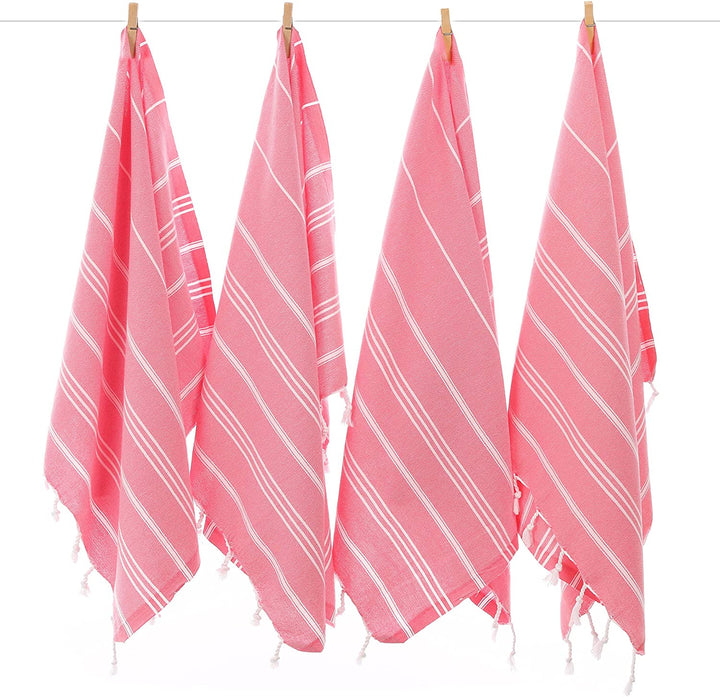 Set of four pink striped hand towels with white lines and tassel fringe, hanging