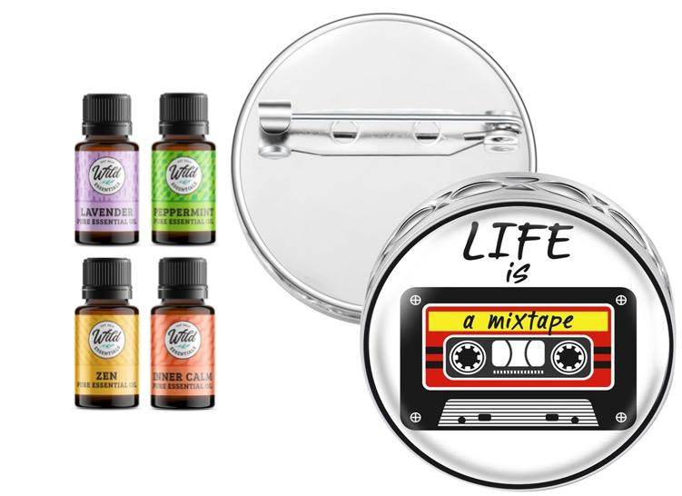 Round silver pin brooch diffuser with mixtape graphic and four essential oil bottles, ready to use