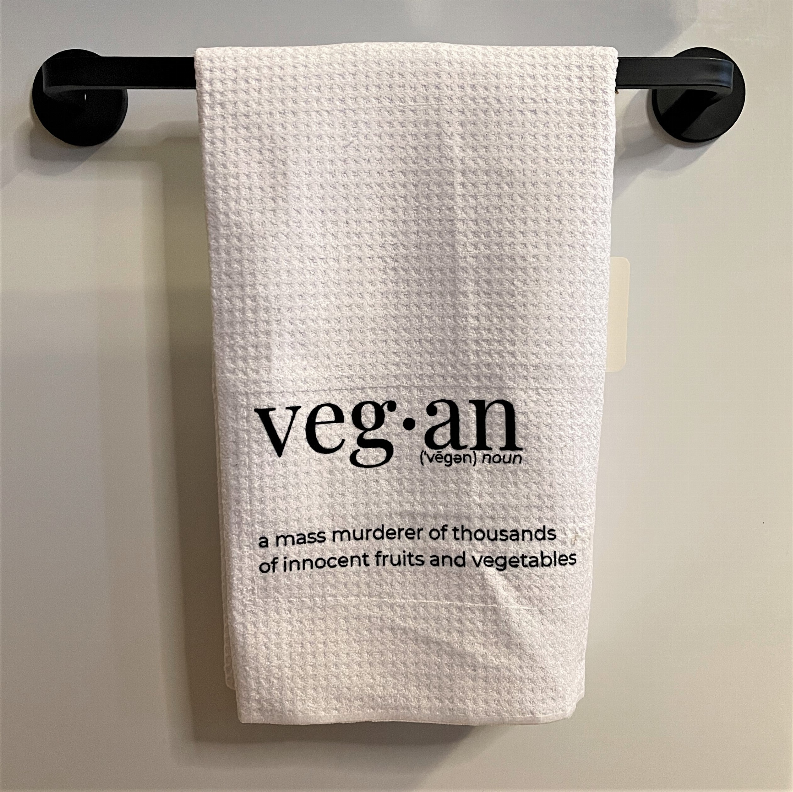 White tea towel with 'veg·an' print and quote about fruits and vegetables
