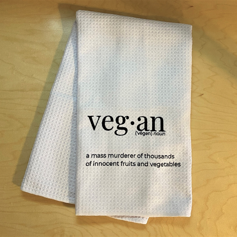 Off-white tea towel with 'veg·an' print and quote about fruits and vegetables