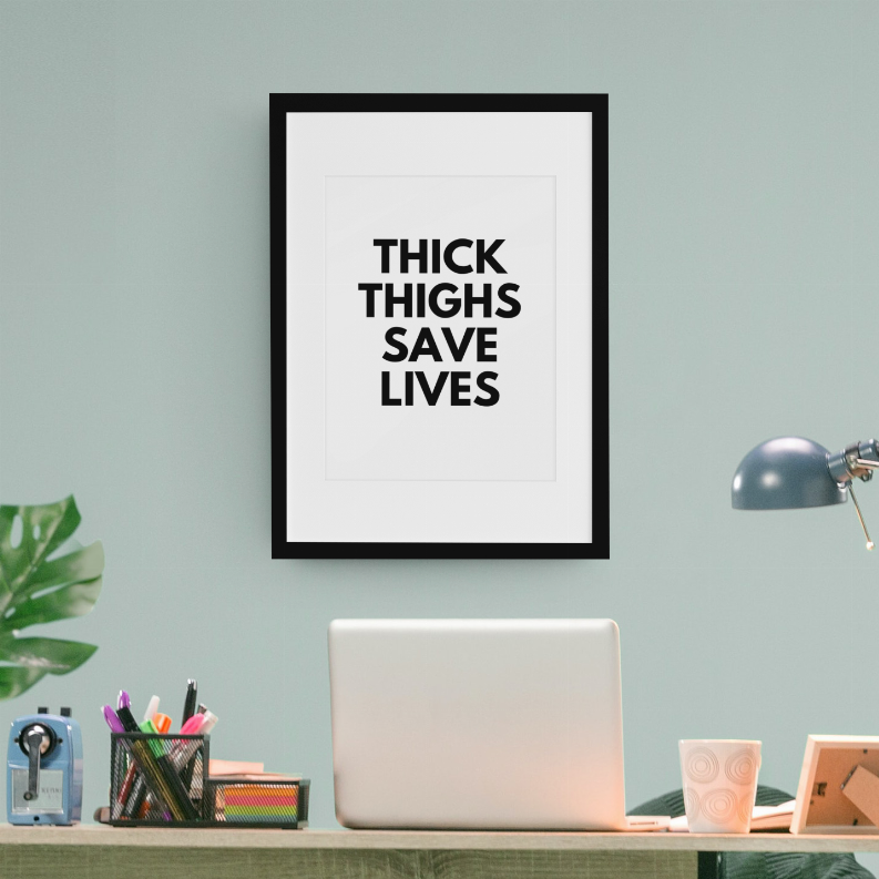 Framed wall art print with bold black "THICK THIGHS SAVE LIVES" text