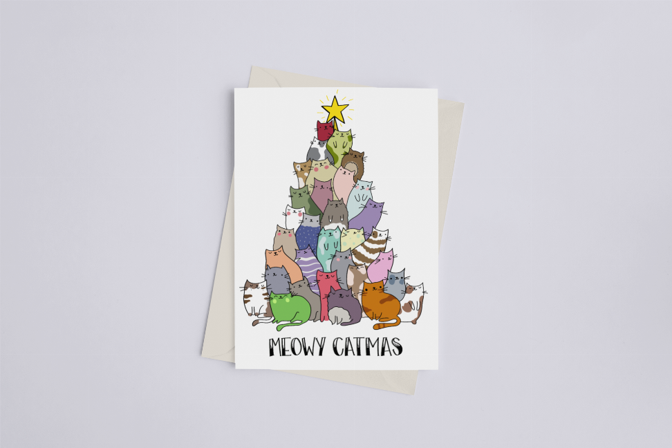 Greeting card with cartoon cats cluster, star topper, and MEOWY CATMAS text