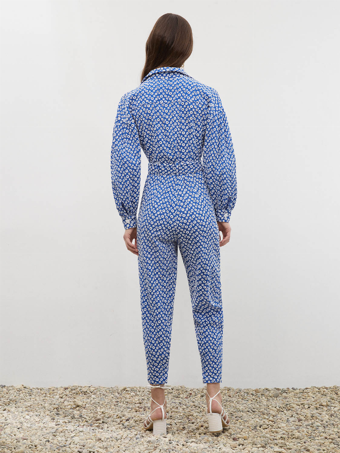 Royal blue patterned jumpsuit with self-belt waist and full-length slim legs, back view