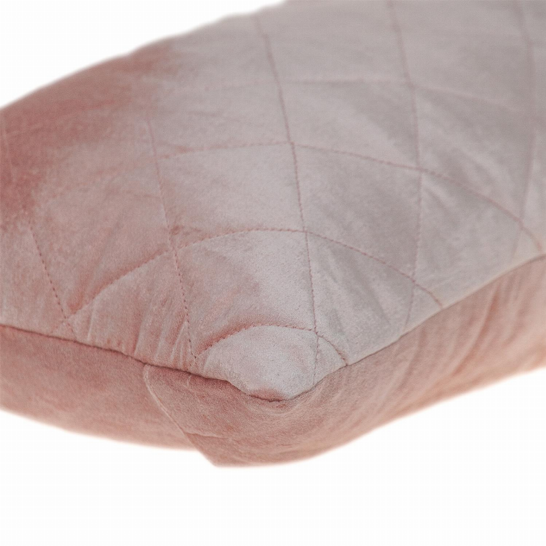 Pink quilted pillow corner with diamond stitching and stitched edge