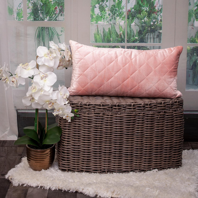 Pink quilted throw pillow with diamond stitch pattern