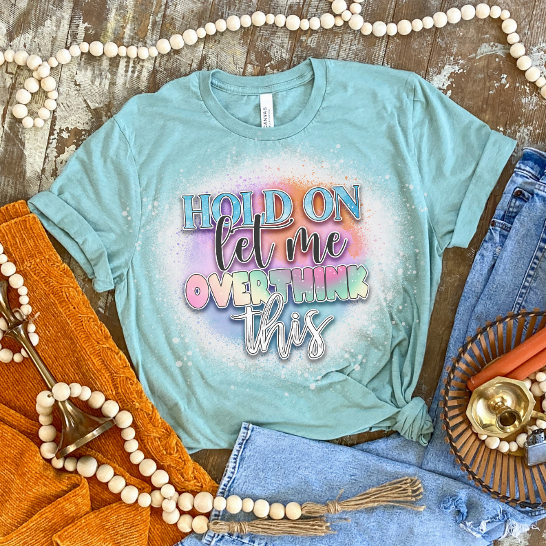 Light blue bleached graphic T-shirt with colorful 'Hold On Let me overthink this' text