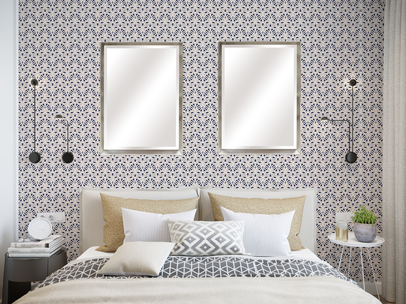 Two silver tray frame rectangular wall mirrors on a patterned wall