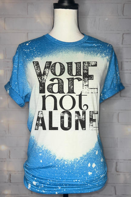 Bleached graphic T-shirt in blue with large black "You are not alone" print