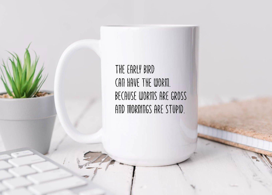 White ceramic coffee mug with printed quote and visible handle