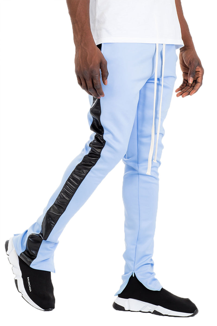 Light blue track pants with black side stripe and white drawstring ankle ties