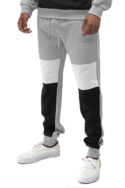 Color-block mono sweatpants in light grey with black paneling, jogger cuffs, drawstring waist