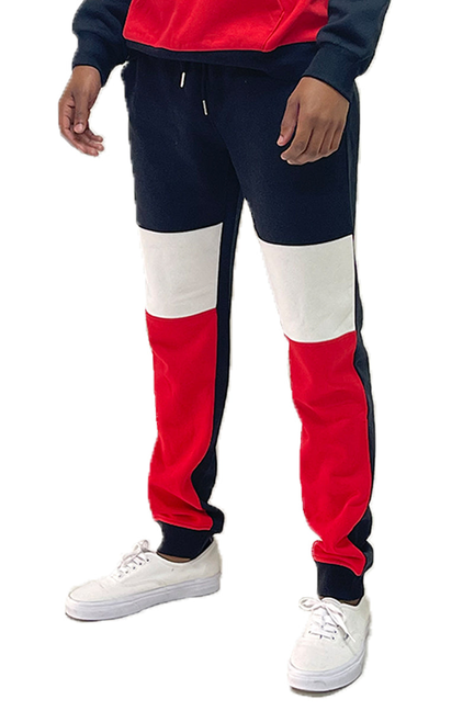 Color-block sweatpants: navy, white, and red panels; tapered jogger style