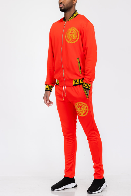 Red tracksuit set with zip jacket and lion head crest logo on chest and pants